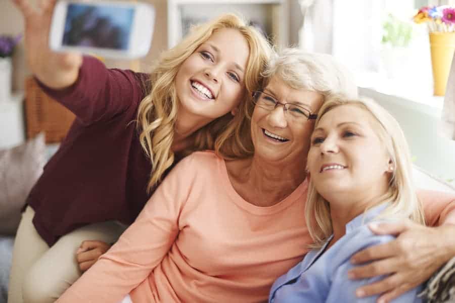 woman taking a selfie with mom and grandmother