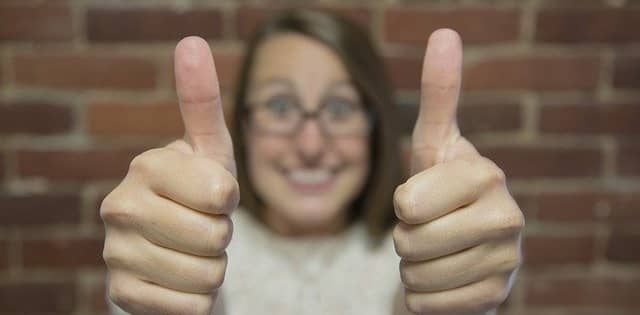 woman with both thumbs up